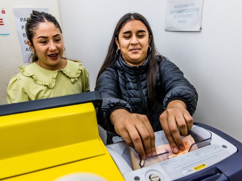 Women paying a loan instalment in Argentina
